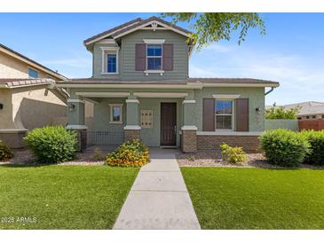 Charming two-story home with a well-maintained lawn and a welcoming front porch at 3881 E Galveston St, Gilbert, AZ 85295