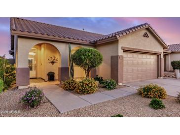 Charming single-story home with a well-manicured front yard and two-car garage, showcasing curb appeal at 40713 N Citrus Canyon Trl, Phoenix, AZ 85086