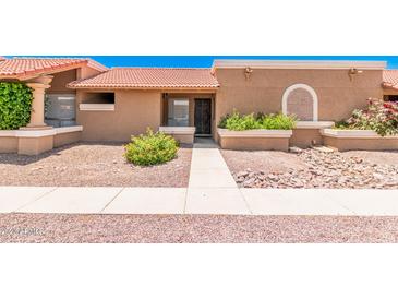 Charming single-story home with desert landscaping, tiled roof, and walkway to the front door at 520 W Hononegh Dr # 2, Phoenix, AZ 85027