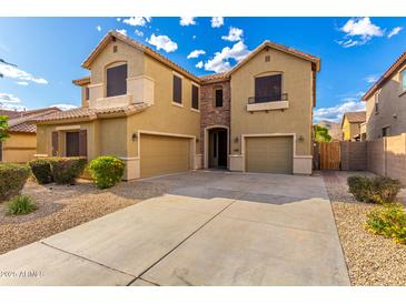 Inviting two-story home featuring a spacious three-car garage and a well-maintained gravel front yard at 7220 W Ashby Dr, Peoria, AZ 85383