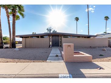 Stunning exterior showcasing mid-century modern design, desert landscaping, and a welcoming walkway to the front door at 7604 N 46Th Ave, Glendale, AZ 85301