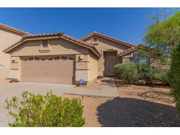Charming single-story home with a well-maintained front yard and a two-car garage in a sunny setting at 10431 E Morning Star Dr, Scottsdale, AZ 85255