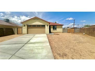 Charming single-story home featuring a neutral color, two-car garage, and a well-kept driveway at 11216 W Apache St, Avondale, AZ 85323