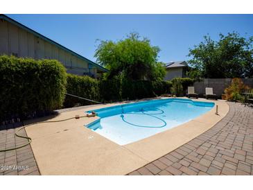 Sparkling pool with a spacious deck, perfect for swimming and enjoying the outdoors at 15212 N 37Th Ave, Phoenix, AZ 85053