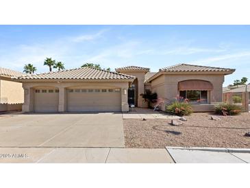Charming single-story home featuring a three-car garage and desert landscaping for low-maintenance appeal at 1896 E Stephens Dr, Tempe, AZ 85283