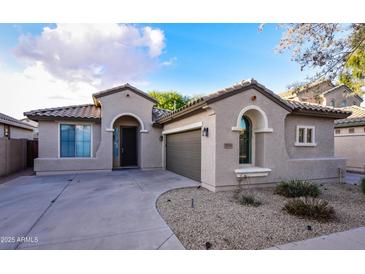Charming single-story home featuring a tile roof, desert landscaping and neutral-toned stucco facade at 21050 E Tierra Grande --, Queen Creek, AZ 85142