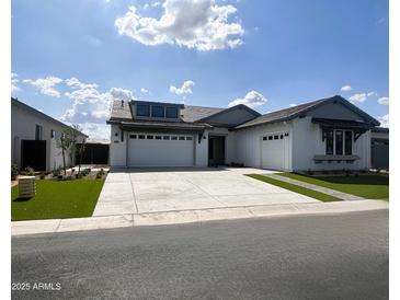 Charming single-story home with a two-car garage and manicured landscaping at 24088 S 218Th Pl, Queen Creek, AZ 85142