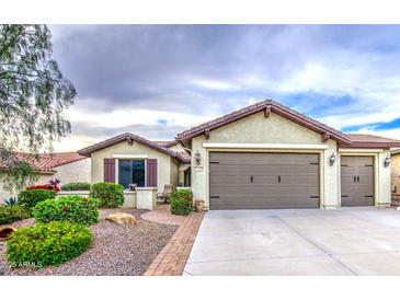 Charming single-story home with a well-maintained front yard and attached two-car garage at 27158 W Potter Dr, Buckeye, AZ 85396