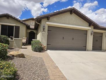 Charming single-story home with a two-car garage, desert landscaping, and a welcoming entryway at 27158 W Potter Dr, Buckeye, AZ 85396