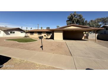 Charming one-story home featuring a covered parking area, low maintenance yard, and neutral color palette at 3434 W Augusta Ave, Phoenix, AZ 85051