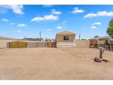 A charming single story home with a desert landscaped front yard and visible mailbox at 633 S 96Th St, Mesa, AZ 85208