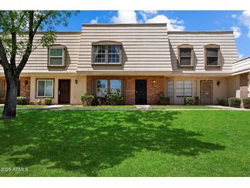 Charming townhome with tidy front yard, and well-maintained facade at 6743 S Jentilly Ln, Tempe, AZ 85283
