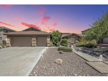 Beautiful single-Gathering home with a large garage, desert landscaping, and a long driveway at 9576 W Blue Sky Dr, Peoria, AZ 85383