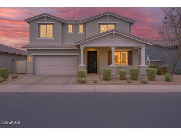 Charming two-story home with a well-maintained front yard and a two-car garage at 9856 E Palladium Dr, Mesa, AZ 85212