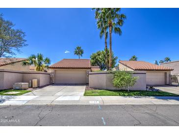 Charming single-story home featuring a well-maintained yard, attached garage, and classic southwestern architecture at 11144 N 109Th Way, Scottsdale, AZ 85259