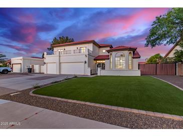 Stunning two-story home with a manicured lawn, red tile roof, and a three-car garage at 1349 N Lakeshore Dr, Chandler, AZ 85226