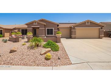 Charming single-story home with desert landscaping and a three car garage at 20427 N 88Th Dr, Peoria, AZ 85382
