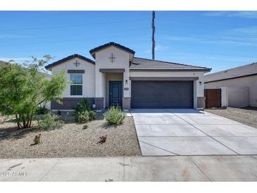 Charming single-story home featuring a well-manicured yard and a two-car garage at 23937 W Hopi St, Buckeye, AZ 85326