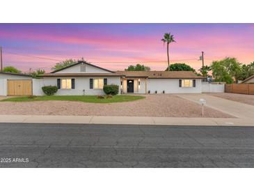 Charming home with a manicured front yard, gravel landscaping, and a welcoming facade at 2614 E Mountain View Rd, Phoenix, AZ 85028