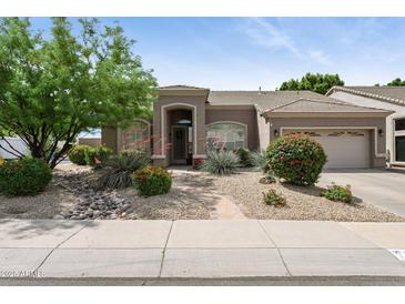 Charming single-story home featuring a desert landscaped front yard and tiled roof at 26271 N 46Th St, Phoenix, AZ 85050