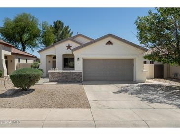 Charming single-story home with a two-car garage and desert landscaping at 2641 E Brooks St, Gilbert, AZ 85296