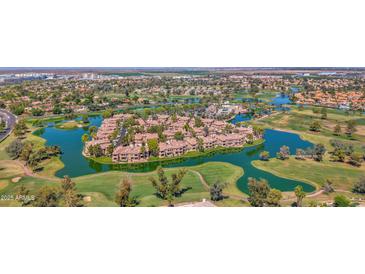 Stunning aerial view of lakeside homes on a lush golf course community, offering serene waterfront living at 3800 S Cantabria Cir # 1077, Chandler, AZ 85248