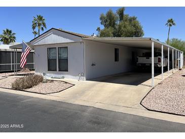 Charming single-story home features a carport and low-maintenance desert landscaping at 9302 E Broadway Rd # 49, Mesa, AZ 85208