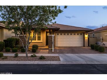 Charming single-story home featuring a two-car garage, brick driveway, and well-manicured landscaping at 10539 E Corbin Ave, Mesa, AZ 85212