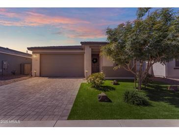 Charming single-story home featuring a low maintenance yard with a well-manicured tree and a paver driveway at 11357 E Unger Ave, Mesa, AZ 85212