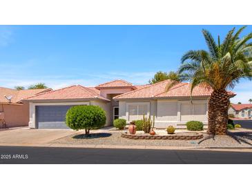 Charming single-story home featuring a tile roof, desert landscaping, and a two-car garage at 1642 E Palm Beach Dr, Chandler, AZ 85249