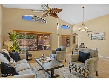 Bright living room featuring high ceilings, large windows, and stylish furnishings with a ceiling fan at 16648 W Adams St, Goodyear, AZ 85338