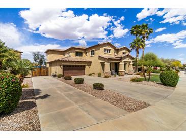 Inviting two-story home featuring desert landscaping, a spacious driveway, and a convenient two-car garage at 18330 W Woodrow Ln, Surprise, AZ 85388
