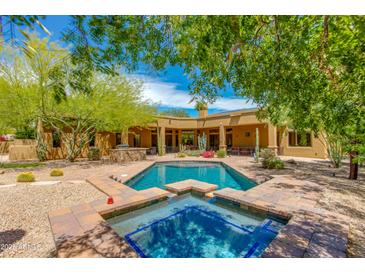 Private pool with jacuzzi and desert landscaping, designed for relaxation and entertainment in the backyard at 26156 N 88Th Way, Scottsdale, AZ 85255