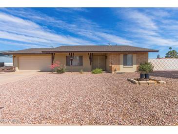 Charming single-story home with a brick and beige facade, complemented by a well-maintained, desert-landscaped front yard at 4106 W Mission Ln, Phoenix, AZ 85051