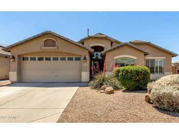 Charming single-story home featuring a well-maintained landscape and a two-car garage at 4617 W Alicia Dr, Laveen, AZ 85339