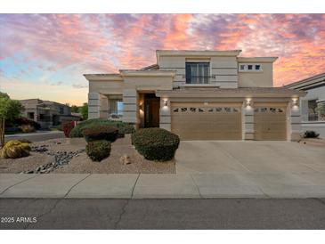 Stunning two-story home featuring a three-car garage and well-manicured desert landscaping at 4812 E Daley Ln, Phoenix, AZ 85054