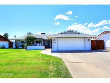 Charming single-story home with a well-manicured lawn and two-car garage, perfect for suburban living at 5634 N 39Th Ave, Phoenix, AZ 85019
