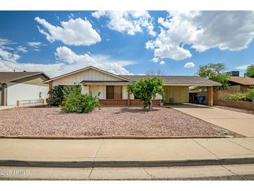 Charming single-story home featuring low maintenance desert landscaping and a covered carport at 8741 W Osborn Rd, Phoenix, AZ 85037