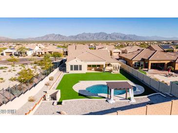 This aerial view showcases a private backyard with pool, pergola, and lush artificial turf at 14552 S 182Nd Dr, Goodyear, AZ 85338