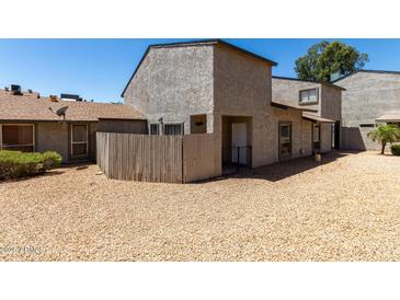 Two-story townhome featuring a private gravel front yard and neutral stucco facade at 15407 N 2Nd St, Phoenix, AZ 85022