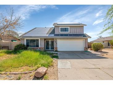 Charming two-story home featuring a two-car garage, solar panels, and front yard at 17819 N 46Th Dr, Glendale, AZ 85308
