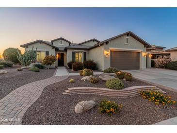 Charming single-story home with desert landscaping and a paved walkway leading to the front door at 20506 N 271St Ave, Buckeye, AZ 85396