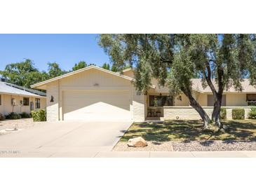 Charming single-story home with a well-maintained lawn and a two-car garage, offering comfort and convenience at 21218 N Aurora Dr, Sun City West, AZ 85375