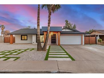 Charming single-story home featuring palm trees, a modern entrance, and a well-manicured front yard at 2905 W Campo Bello Dr, Phoenix, AZ 85053