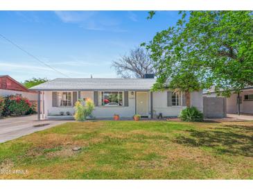 Charming single-story home featuring a well-maintained lawn and a freshly painted exterior at 3243 E Sheridan St, Phoenix, AZ 85008