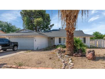 Charming single-story home with low-maintenance landscaping and a two-car garage, set against a bright sky at 4813 W Belmont Ave, Glendale, AZ 85301