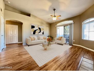 Bright living room boasts neutral furniture, wood floors and sliding glass door for lots of natural light at 5335 E Shea Blvd # 2045, Scottsdale, AZ 85254