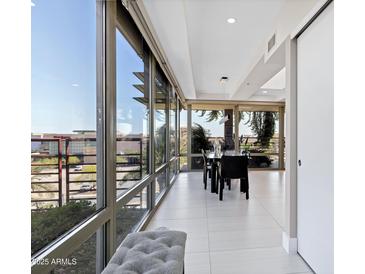 Bright dining room with floor to ceiling windows and a modern dining table set at 7137 E Rancho Vista Dr # 6011, Scottsdale, AZ 85251