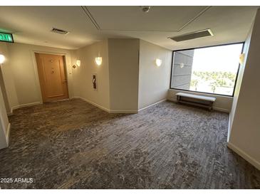 Hallway with seating and large window offering nice natural light at 1040 E Osborn Rd # 602, Phoenix, AZ 85014