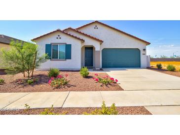 Charming single-story home featuring desert landscaping, a blue garage door, and a covered front entryway at 1123 E Meadowbrook Dr, Casa Grande, AZ 85122